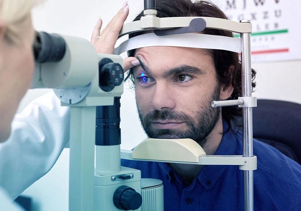 A man undergoing a detailed eye check with a slit-lamp device before considering LASIK surgery.